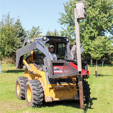 removing trees with skid steer|post puller skid steer attachment.